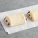A white rectangular paper with two Bridor Perfect Butter Chocolatines inside.