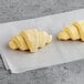 Two Bridor Ready to Bake Mini Croissants on a white paper.