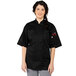 A woman wearing a black Uncommon Chef Tingo chef coat smiling.