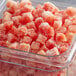 A clear container filled with Pitaya Foods IQF natural watermelon cubes.