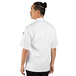 A man wearing a white Uncommon Chef short sleeve chef coat.