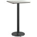 A white and black Lancaster Table & Seating bar height table with a black base.