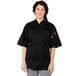 A woman wearing a black Uncommon Chef Tingo short sleeve chef coat.
