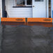 A flooded house with a Quick Dam flood gate and orange signs.