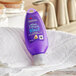 A purple bottle of Aussie 3 Minute Deep Conditioner with white text on a white towel.