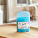 A blue plastic container of Secret Powder Fresh Scent Antiperspirant Deodorant on a wooden tray.