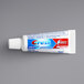 A white tube of Crest Cavity Protection toothpaste with a red and blue label.