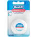A case of 24 blue and red packages of Oral-B Essential Mint Dental Floss with a white floss inside.