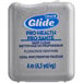 An Oral-B silver container of Glide Pro-Health dental floss with blue text.