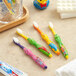 A group of Crest Kid's Sesame Street soft toothbrushes with cartoon characters on a table.