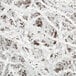Spring-Fill White Radiance Crinkle Cut paper shred. A close up of shredded paper on a white background.