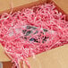 A box with Spring-Fill Light Pink Radiance Crinkle Cut paper inside.