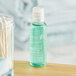 A case of Nourish Mint Mouthwash bottles with green liquid.