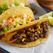 A group of tacos on a plate with Beyond Meat beef crumbles.