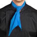 A man wearing a Uncommon Chef royal blue neckerchief over a black shirt.