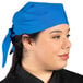 A woman wearing a royal blue Uncommon Chef bandana.