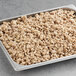 A baking pan filled with Beyond Meat plain crumbles on a table.