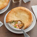 A Country Chef baked chicken pot pie with a fork in it.