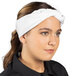 A woman wearing a white Uncommon Chef bandana on her head.