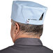 A man wearing a sky blue Uncommon Chef skull cap.