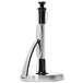 A silver and black metal OXO Good Grips paper towel holder on a counter.
