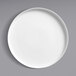 A white Oneida Scandi porcelain plate with a raised rim on a gray surface.