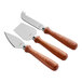 A group of Acopa stainless steel cheese knives with natural pakkawood handles.