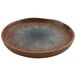 A close-up of a cheforward by GET Savor 6" round clay Azul Iris melamine plate with a brown and blue design.