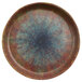 A round cheforward by GET Savor melamine plate with a blue and brown speckled design.