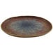 A cheforward oval melamine plate with a blue and red speckled design.
