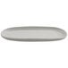 A white oval cheforward melamine platter with a small handle.