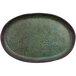 A green oval cheforward by GET melamine plate with brown speckles.