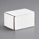 A white Lavex corrugated mailer box on a gray surface.