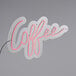 A white neon sign that says "Coffee" in pink.