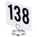 An American Metalcraft chrome swirl base card holder with a white table number with black numbers on it.