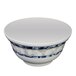 A white melamine noodle bowl with blue dragon designs on the rim.