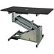 A black Groomer's Best grooming table with a silver frame.