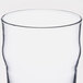 An Arcoroc English pub glass with a white background.