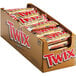 A cardboard box of TWIX chocolate cookie bars individually wrapped in candy bars.
