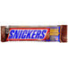 A close up of a SNICKERS chocolate candy bar with caramel and nuts.