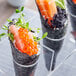 Vegan Caviar-Art sushi rolls with black sesame seeds on a plate.