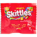 A red SKITTLES package with text and a rainbow design.