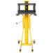 A yellow and black Vestil portable hand winch lifter.
