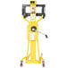 A yellow Vestil portable hand winch lifter with wheels.