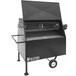A black Holstein Manufacturing propane grill with a lid and wheels.