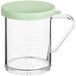 A clear polycarbonate shaker with a green lid.