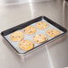 A Vollrath non-stick sheet pan with cookies on it.
