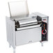 An APW Wyott vertical conveyor bun grill toaster on a counter in a professional kitchen with the lid open.