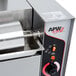 An APW Wyott vertical conveyor bun grill toaster on a counter in a professional kitchen.