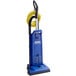 A blue Clarke CarpetMaster 215 vacuum cleaner with a yellow tube.